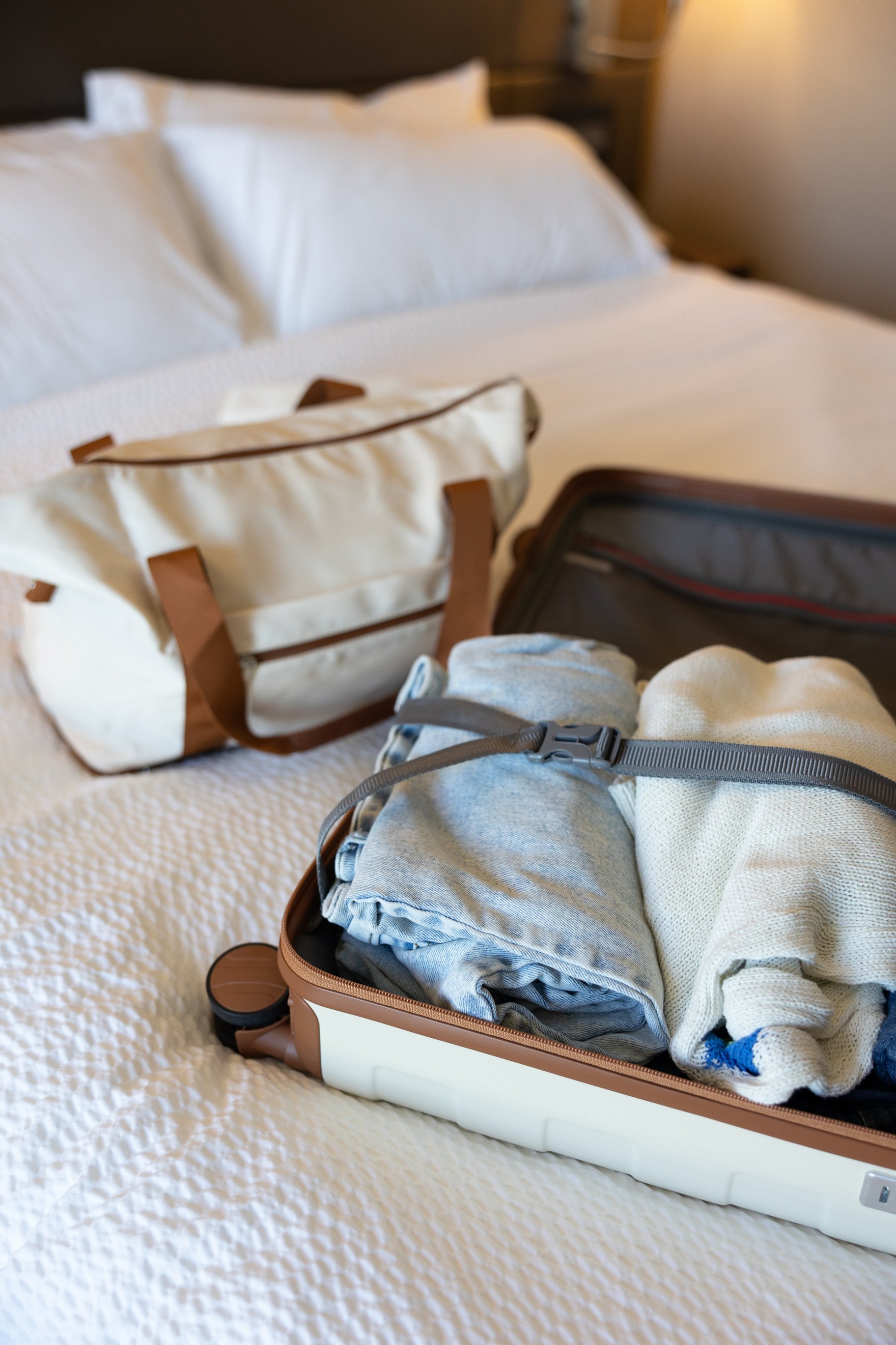 Staycation Luggage on a Hotel Bed